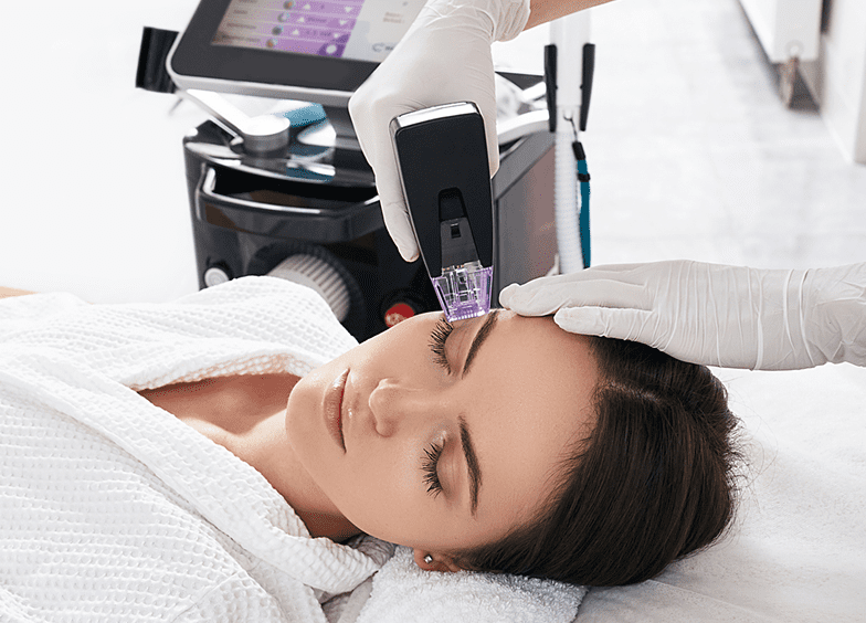 Woman receiving laser skincare treatment