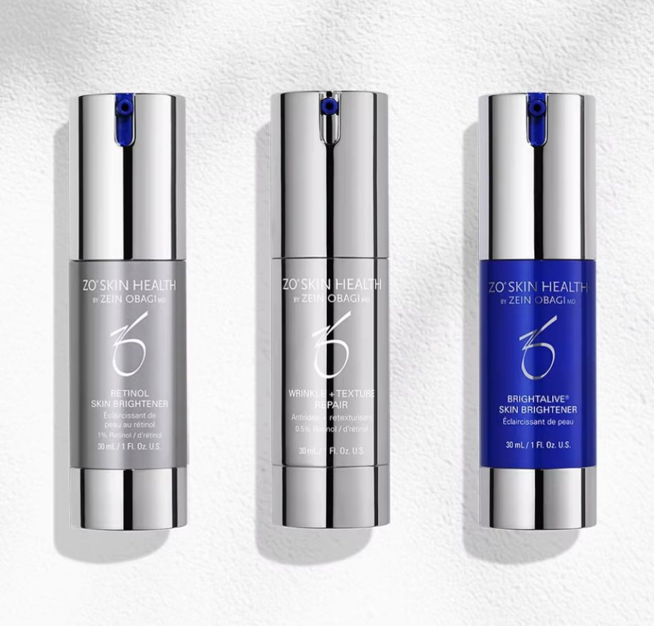 Three sleek skincare bottles with metallic and blue designs.