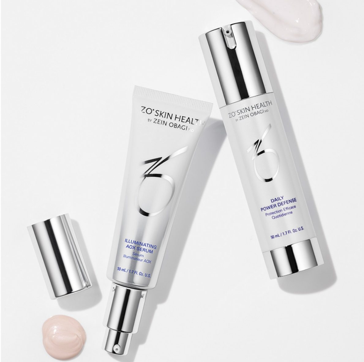 Two skincare products with silver caps and creamy textures on a white surface.