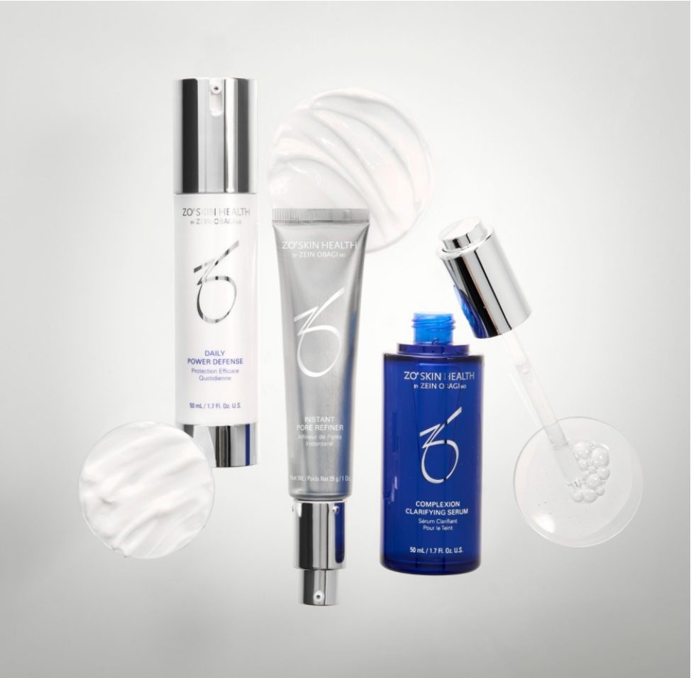 A set of skincare products with white, blue, and silver packaging on a light background.