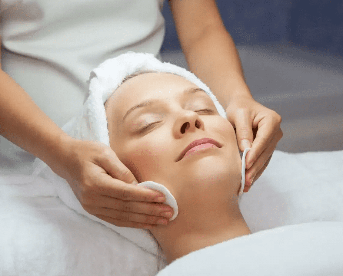 Woman receiving a relaxing facial treatment at a spa.