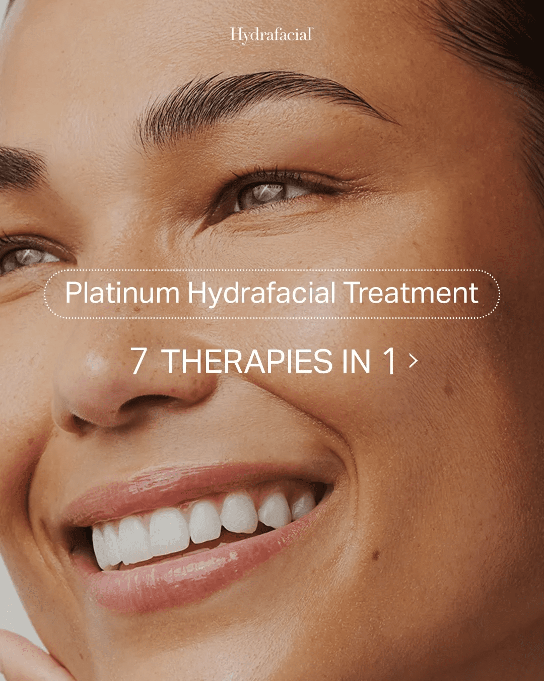 Smiling woman promoting Platinum Hydrafacial Treatment offering 7 therapies in 1.